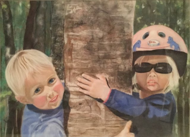 Tree Huggers: Two small children hugging a tree trunk; one wears a bike helmet and sunglasses.